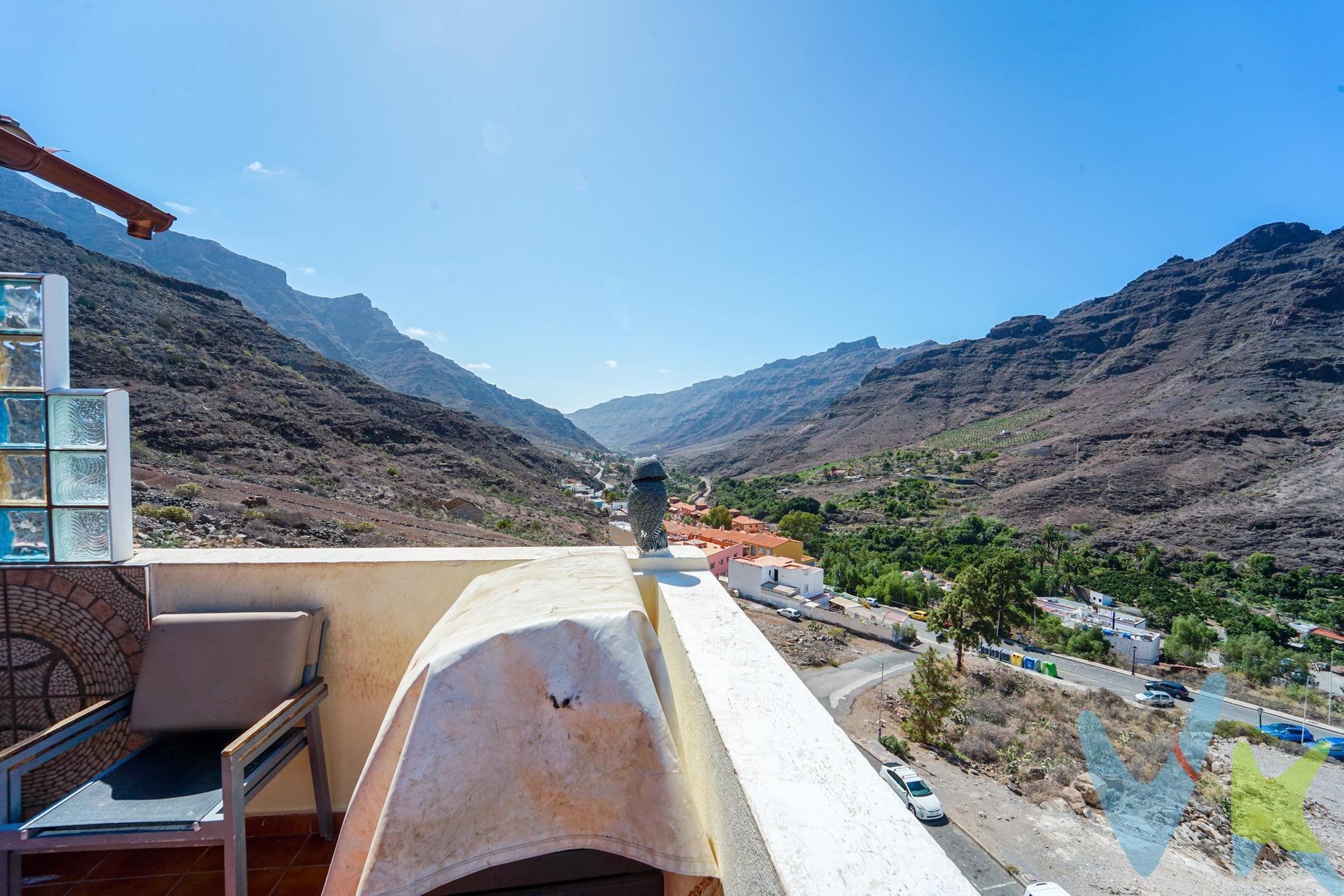 Esta vivienda se encuentra al final de una calle tranquila en el pueblo de Mogán, con agradables vistas hacia el barranco y las montañas. La propiedad se distribuye en tres plantas, ofreciendo un amplio espacio para disfrutar, ideal para una familia. En la planta principal, la cocina destaca por su gran tamaño y está completamente equipada, conectando con la zona de comedor, perfecta para reuniones familiares. El sótano ofrece un espacio versátil que puede utilizarse como sala de juegos o para almacenaje. En la planta superior, actualmente hay dos dormitorios, aunque es fácilmente reconvertible a tres, tal como estaba en su diseño original. La azotea ha sido parcialmente cerrada, proporcionando un espacio cerrado con cocina, grandes ventanales con vistas, y una zona exterior con hamacas para disfrutar del sol con total privacidad. La vivienda también cuenta con placas solares, una característica moderna y eficiente que contribuye al ahorro energético. Ubicada en la calle El Pino, la casa tiene acceso directo a colegios, supermercados y otros servicios, lo que la convierte en una opción práctica y cómoda para la vida diaria. ###Distribución. La vivienda se distribuye en 3 plantas. En la inferior hay un sótano, La planta baja cuenta con un amplio salón, aseo, comedor y cocina. La segunda planta tiene 2 dormitorios dobles y un baño. La azotea ha sido parcialmente cerrada. Aprox. 151.49 m² (101.49 m² registrados + ampliación de aprox. 50 m²) + azotea de 50 m². ###Aviso legal. El plano publicado debe ser considerado como croquis orientativo, no como reflejo exacto de la realidad física del inmueble, pudiendo existir inexactitud en el trazado del plano y en las medidas. NOTA: La ampliación (sótano) de aprox.50 m² fue construida originalmente sin licencia de obras, estando no obstante consolidada por prescripción urbanística. . Precio no incluye impuestos y gastos de la compraventa. Los más importantes son: Impuesto de Transmisiones Patrimoniales (6,5%), así como los honorarios de Notario, Registro de la Propiedad y gestoría. Generalmente debemos calcular aquí un 8-10% del precio, aunque le entregaremos una estimación detallada para cada propiedad concreta por la que Vd. se interese.