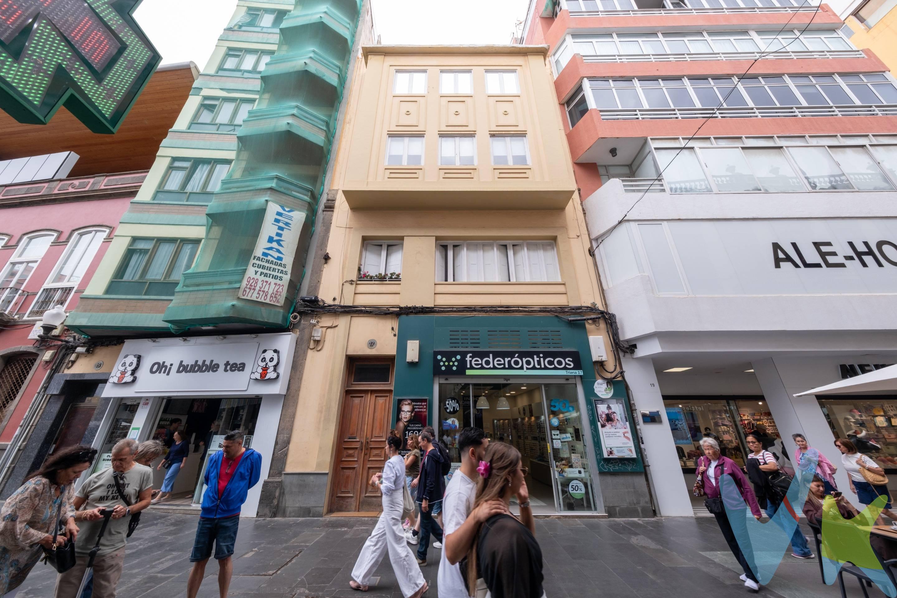 En plena Calle Mayor de Triana, en el corazón de Las Palmas de Gran Canaria, encontramos esta vivienda con carácter, reformada y lista para entrar a vivir. El piso cuenta con una distribución cómoda y actual, con salón, comedor y cocina integrados en un único espacio abierto, cálido y funcional. Dispone de tres dormitorios: dos habitaciones dobles y una habitación sencilla con baño en suite. Además, cuenta con un segundo baño completo con ducha. La vivienda se entrega amueblada y conserva elementos que le aportan personalidad, como los techos altos, las molduras antiguas respetadas, las puertas originales de madera pintada y los suelos de madera en prácticamente toda la casa. La cocina cuenta con pavimento de linóleo. La reforma, realizada a finales de 2020, incluyó la renovación de las instalaciones de luz y agua. Además, dispone de aire acondicionado con bomba de calor en el salón y en la habitación principal. Se encuentra en una tercera planta sin ascensor y no dispone de plaza de garaje, pero cuenta con trastero en la azotea. En ese espacio se encuentra también un aljibe propio y una bomba de presión que ayuda a mantener una buena presión de agua en la vivienda. La azotea es comunitaria, está situada justo encima del piso y ha sido reparada recientemente, con impermeabilización y pavimento nuevo. Dispone de zonas de asiento, mesas, sillas, columpios y barbacoa, lo que la convierte en un espacio muy agradable para disfrutar al aire libre en pleno centro de la ciudad. Una vivienda especial para quienes buscan vivir Triana desde dentro, con todos los servicios a mano y el encanto de una casa con historia. Un piso de ensueño en el centro de la ciudad. . 