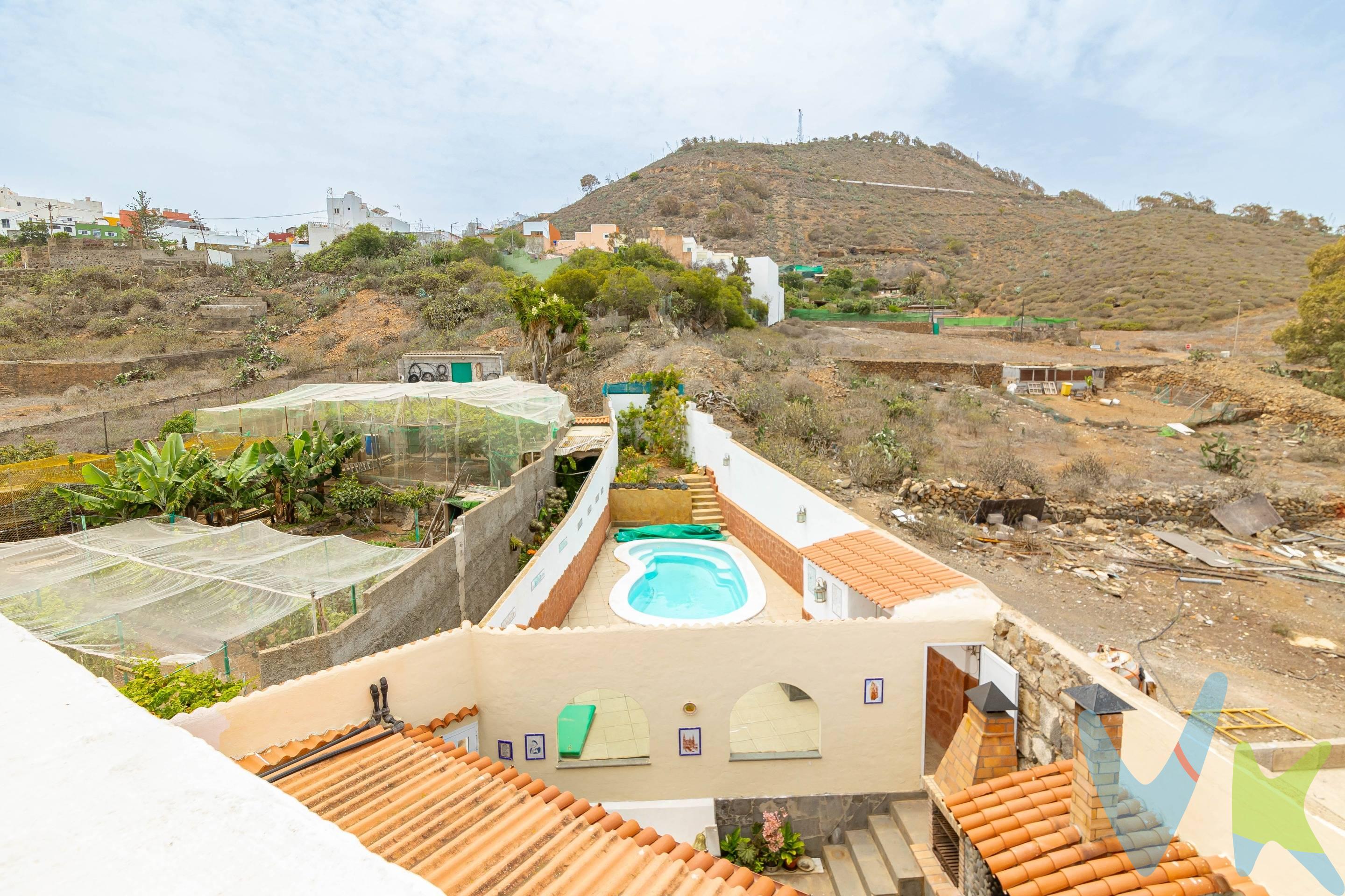 . VENDEMOS, en Arucas, una vivienda que conjuga historia, con las comodidades de nuestra vida diaria, la casa cuenta con entrada para coches, por la que puedes acceder en coche y entrada peatonal, que nos invita a entrar en la zona principal de la casa, que nos recibe, la que antiguamente, era la Escuela de Trasmontaña, ahora se ha convertido en una coqueta bodega, haciendo las delicias del paladar de la familia y amigos que la disfrutan. Ésta bodega, nos da paso a la entrada peatonal de la casa principal, siguiendo el acceso a la entrada, nos recibe un patio central, de estilo rústico, que nos dirige a cualquier estancia. La vivienda está situada en lo que llaman: “Lugar Los Castillejos” una zona muy cercana a nuestra Iglesia de San Juan Bautista, con tan sólo 12 vecinos. Acceso directo a la circunvalación, tanto a la GC2, cómo a la GC1, Se compone, en su totalidad del patio central del que habíamos hablado, 5 dormitorios, 3 baños completos, cocina completa en planta baja y otra en la planta superior, también dispone en cada planta de dos salones. La vivienda es independiente y en los exteriores (todos vallados), disponemos de jardín con rampa que nos lleva al garaje y zona de porche, terraza con barbacoa y horno, además piscina climatizada, con zona de solarium.  . Tanto la vivienda, con su parcela, cómo los terrenos anexos se encuentran escriturados y registrados. DETALLES EXTRA DE ÉSTE CHALET: . La propiedad, cuenta con extras, tales como la wifi y alarma con empresa de reconocido prestigio y sensores en todas las estancias. Vivienda independiente, que se dispone en una sola planta, con el añadido extra de disponer de una segunda planta, moderna, con preciosas vistas de construcción más reciente. Piscina climatizada privada, con zona de solarium. Terraza con barbacoa, comedor y horno. Alarma perimetral, con sensores. . DATOS REGISTRALES: . FINCA 1 que cuenta con más de 800 metros urbanos y casi 1000m2 rústicos. Dónde se encuentra la vivienda de dos plantas con casi 350 metros construidos. El resto de la parcela rústica cuenta con plantaciones de naranjos, limoneros, plataneras, durazneros, guayaberos y 130 cepas de parras en espalderas y terreno dónde se plantan papas y hortalizas regularmente. FINCA 2 cuenta con una superficie de casi 800 metros cuadrados y es rústica, donde hay frutas tropicales, tales como aguacates, mangas, papayeros e higueras. Como añadido, ambas fincas cuentan con agua y están dentro de la Comunidad de Regantes de la Montaña de Arucas. La finca cuenta con contador para recoger el agua y llenar 4 aljibes en la finca, la superficie aproximada está en torno a 80 mil litros. Todos los terrenos que componen la propiedad están sectorizados, en función de las plantaciones y los sistemas de riego fijo que requieren, bien por goteos, aspersión u otros, todo controlado por ordenador. Se vende con un motocultor y utensilios para fumigar, arar y cultivar las fincas. Todas las estancias están canalizadas, para el aprovechamiento del agua de lluvia. . NOTA: En el precio no entra impuestos ni gastos de notaría y registro.-. . . 